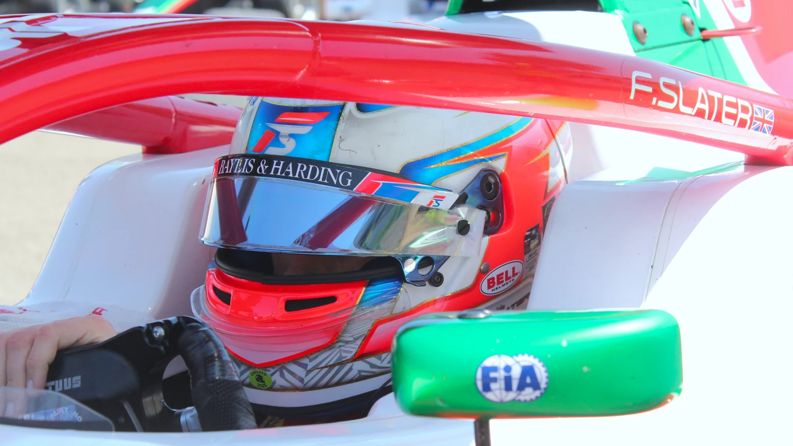 Freddie Slater wearing his helmet in the Prema cockpit at the Hungaroring in 2025