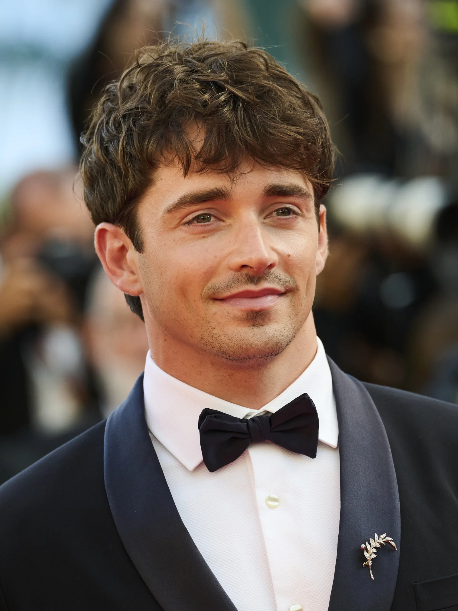 Portrait of Charles Leclerc wearing a suit and bow tie at Cannes in May 2026.