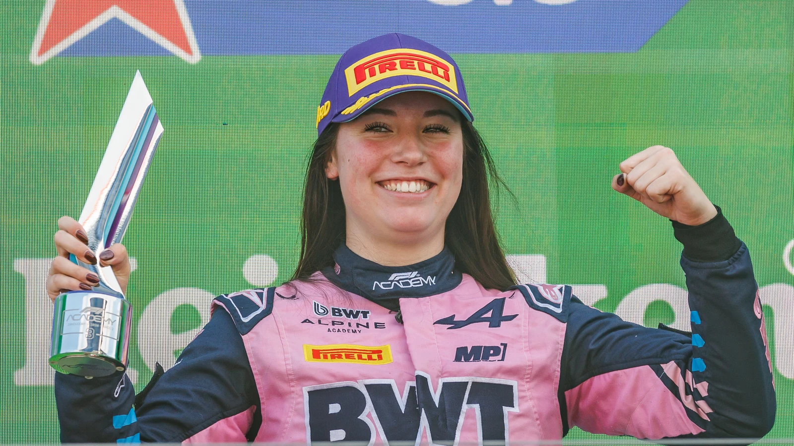 Nina Gademan in her Alpine race suit holding her trophy on the Zandvoort podium in 2026